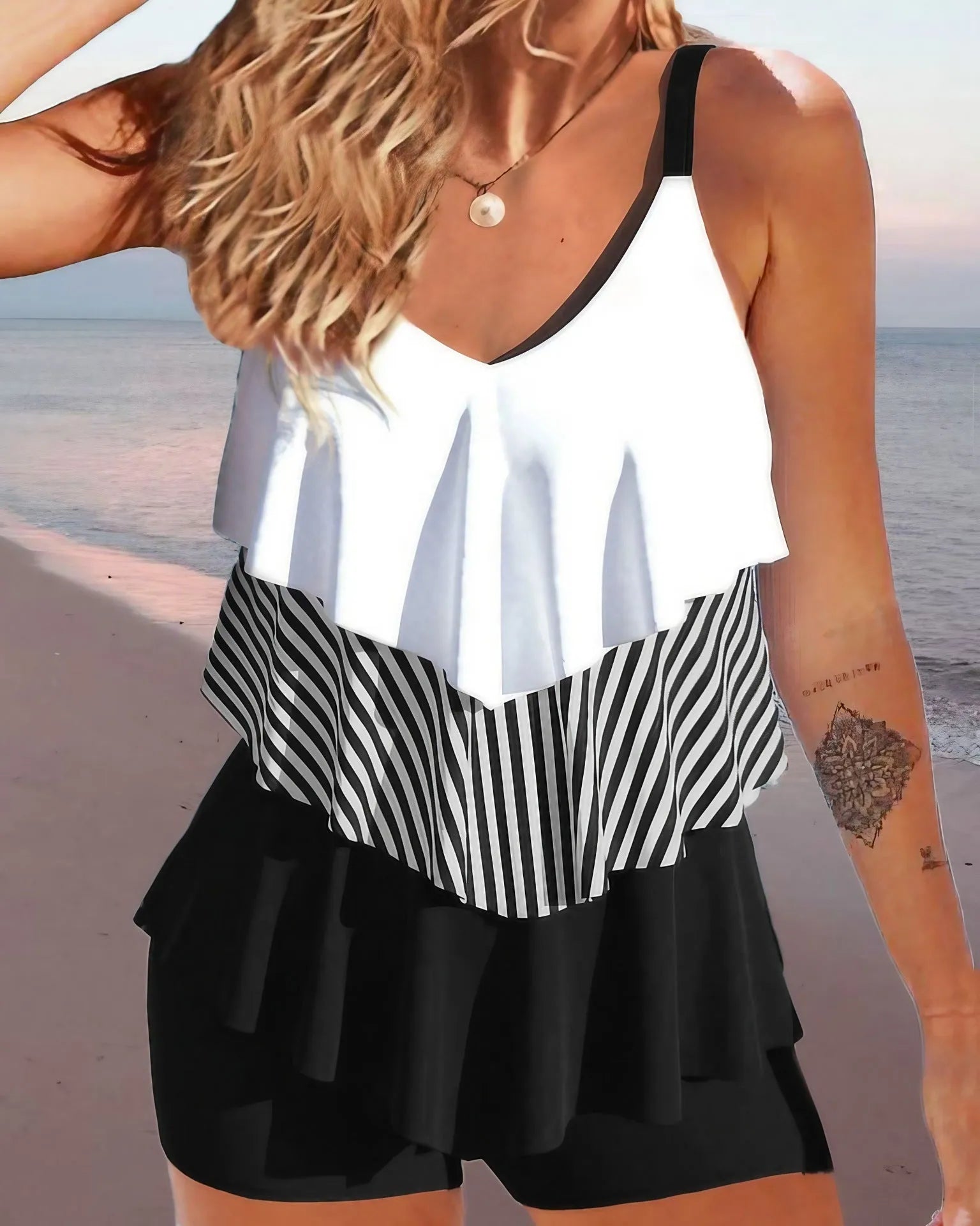 Women's backless bikini swimsuit with spaghetti straps and ruffle detail in a choice of patterns.