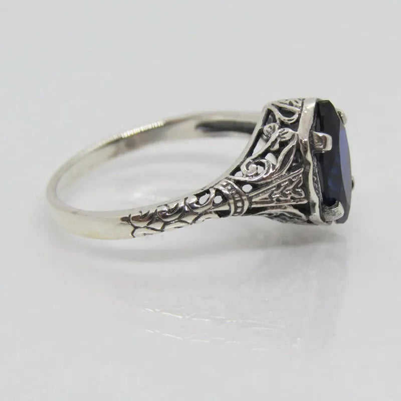 Silver women's ring with geometric hollow pattern in alloy metal showing side profile view