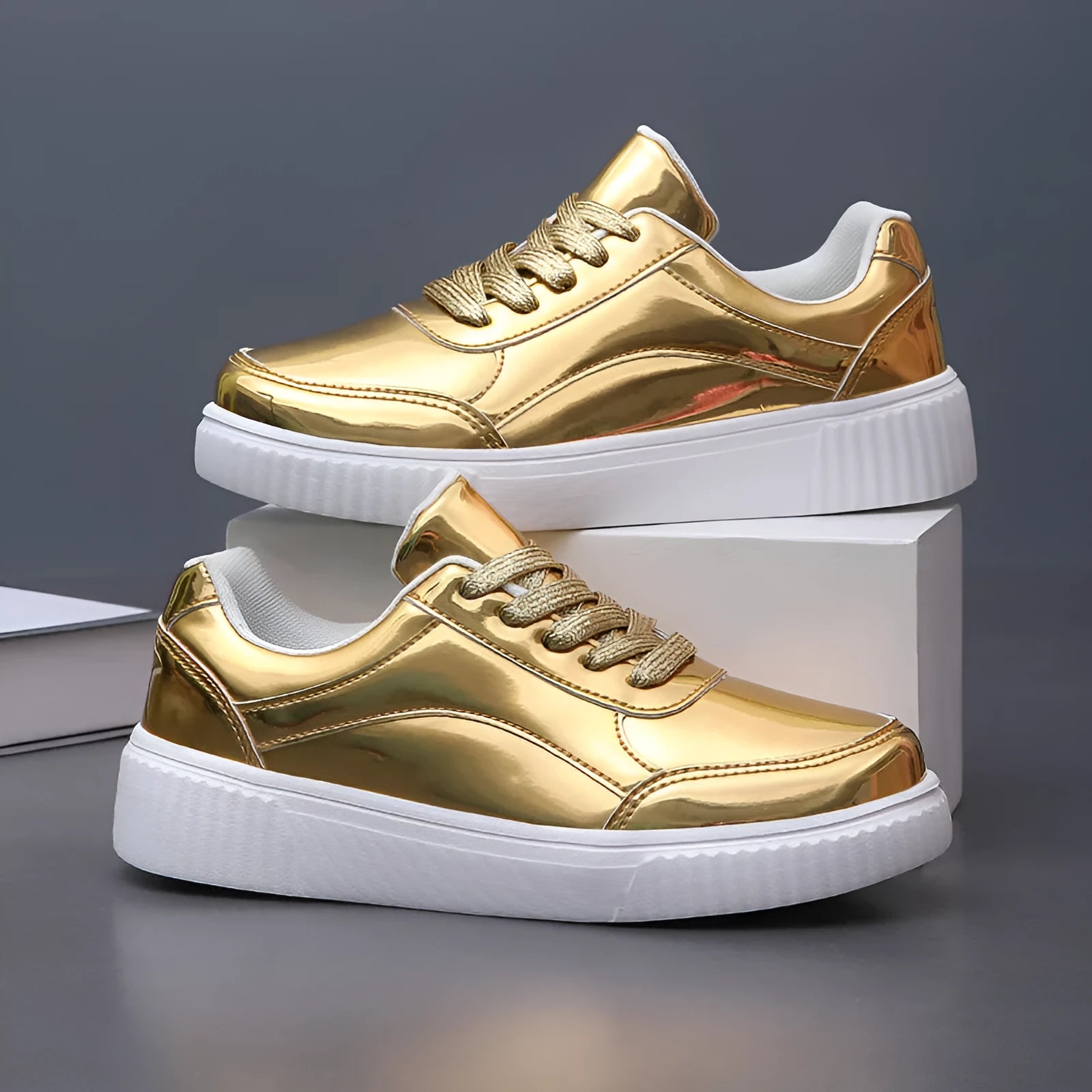 Gold sequinned platform sneaker with round toe and thick MD sole on a white background