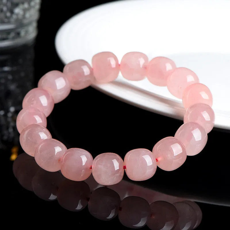 Natural crystal barrel shaped bead bracelet with pink polished geometric beads