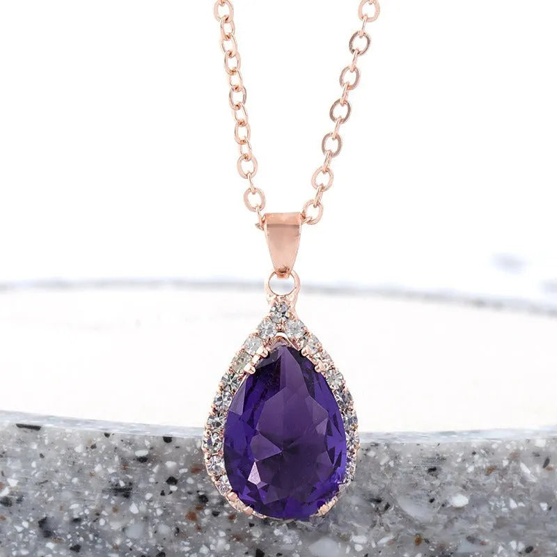 Drop-shaped pendant necklace with rhinestone and gemstone inlay in pink colour option