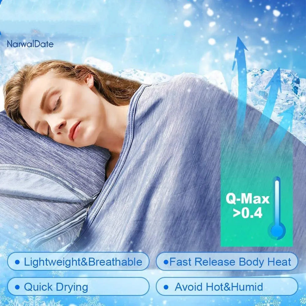 Blue cooling blanket with double-faced texture on a bed, showing its lightweight drape.