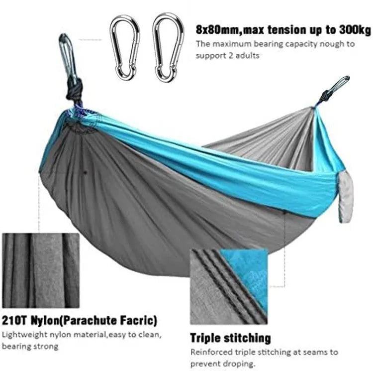 Blue nylon parachute cloth camping hammock hanging between two trees, showing its full 270cm length.