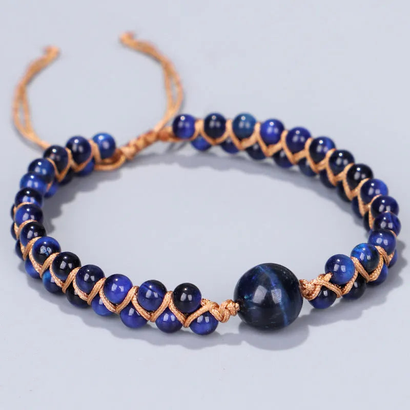 Close-up of a handmade woven pull bracelet with geometric pattern in blue Tigereye stone beads.