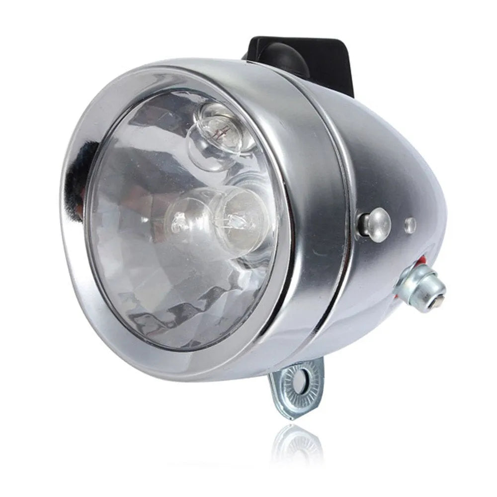 Silver bicycle dynamo generator light kit showing generator unit, wiring, and connectors for front or rear mounting.