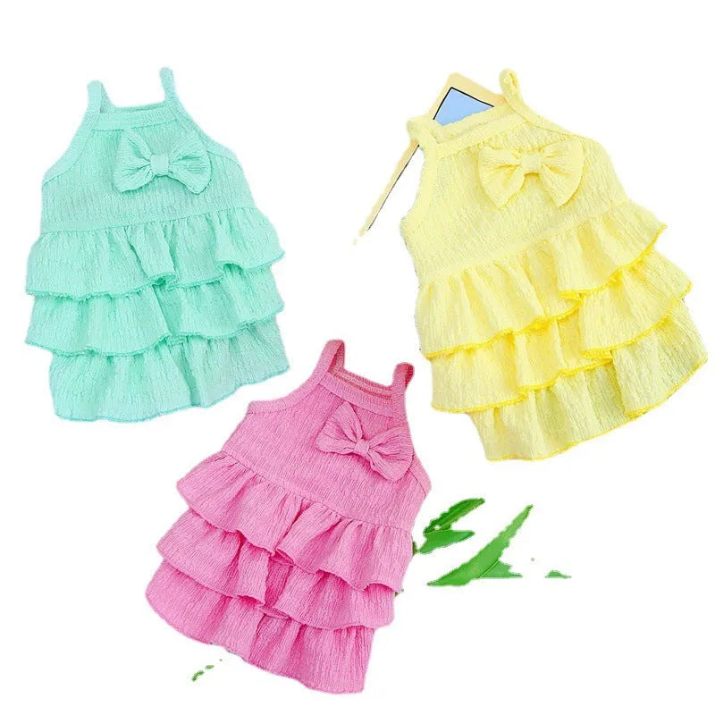 Small dog wearing thin polyester princess dress with layered candy skirt in water green colour
