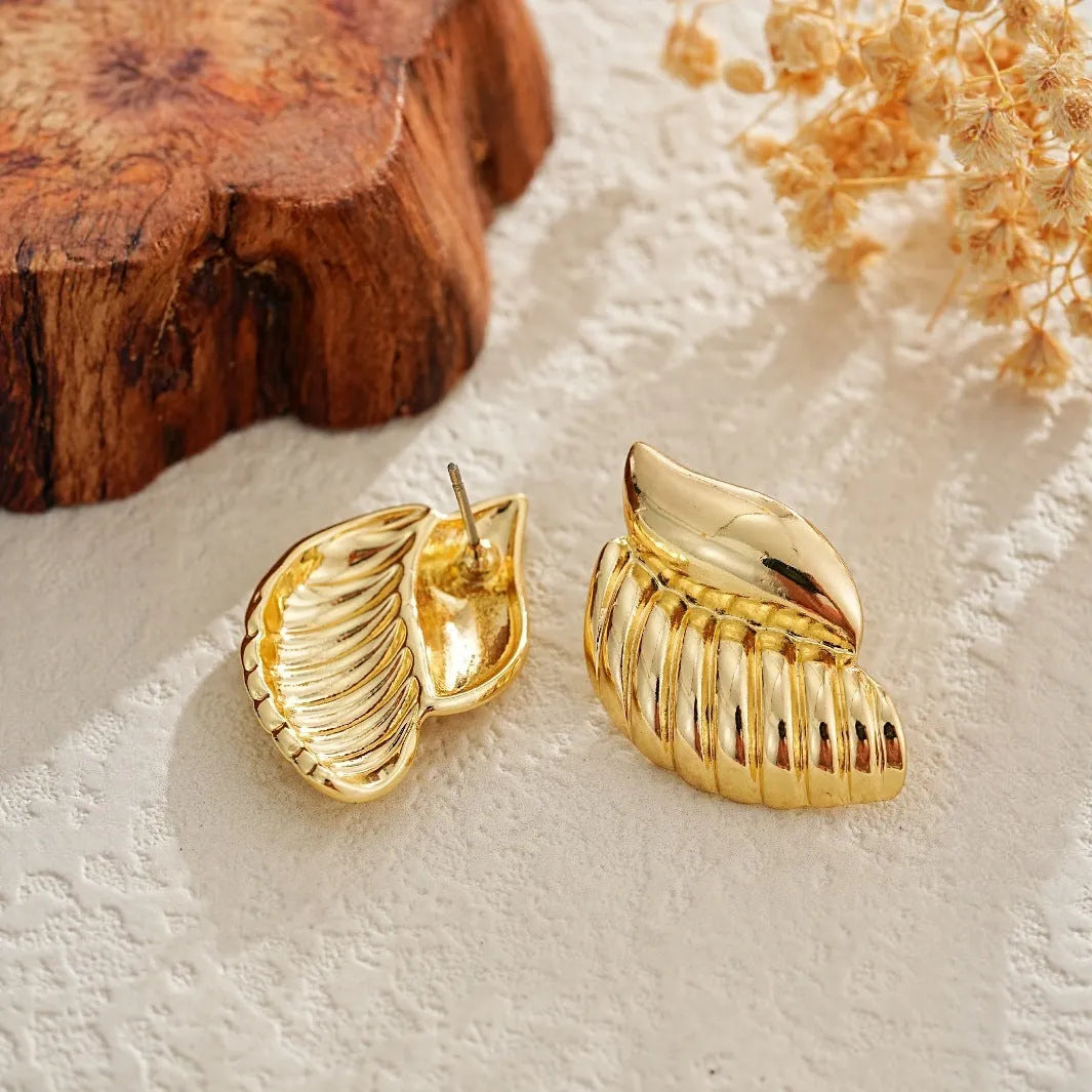 Pair of gold threaded water drop earrings for women on white background