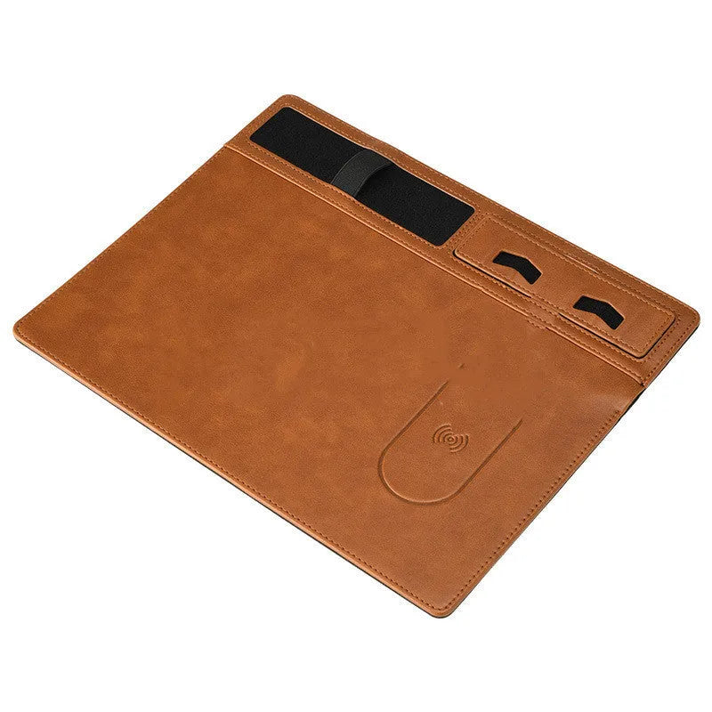 Pink wireless charging mouse pad with integrated mobile phone holder on a wooden desk