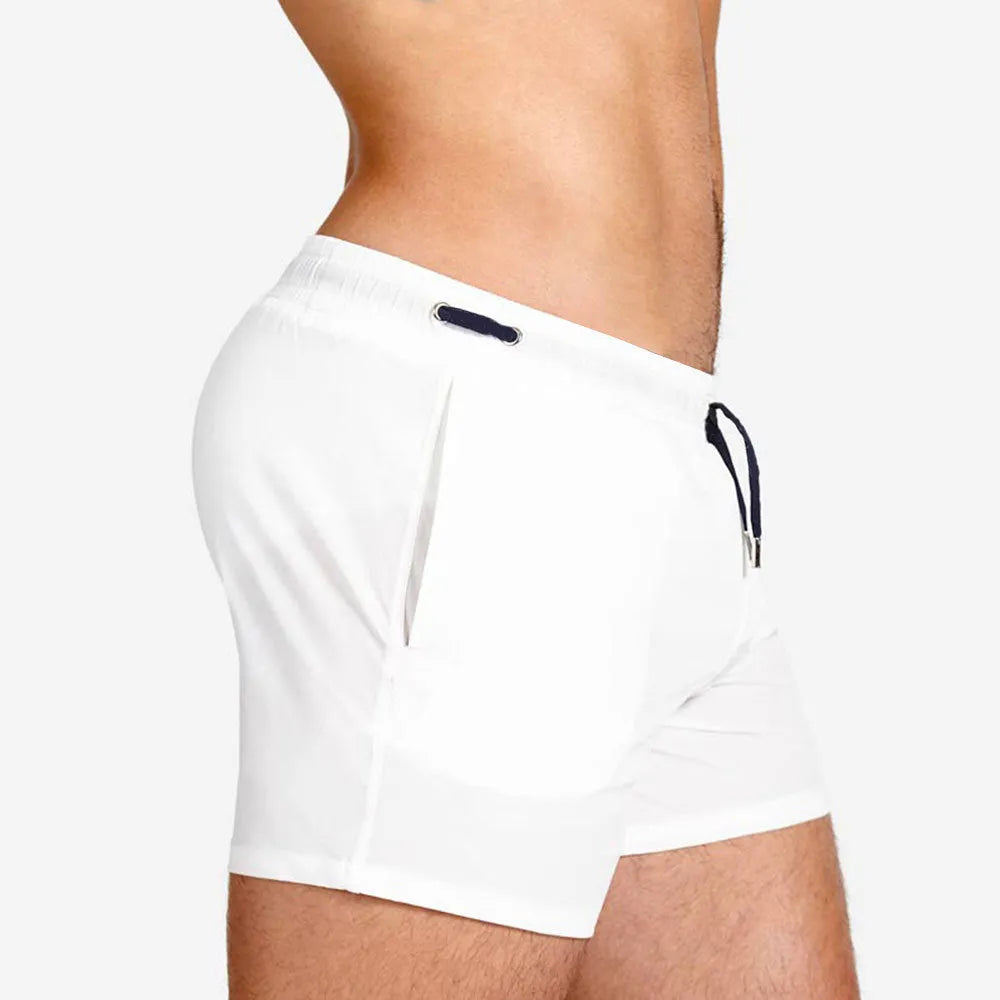 Man's solid colour polyester swimming shorts with mesh lining for sports and fitness.
