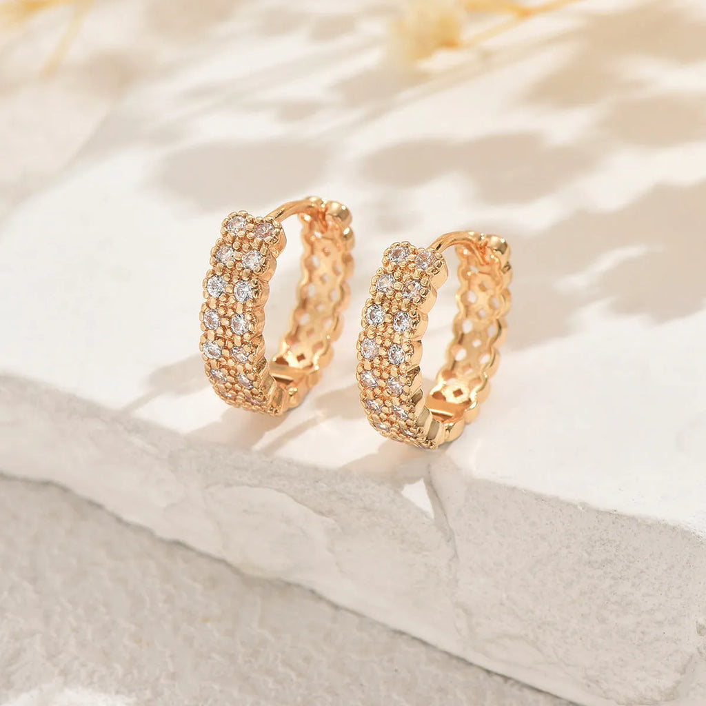 Copper geometry pattern ear studs with round, dot, and ring design elements.