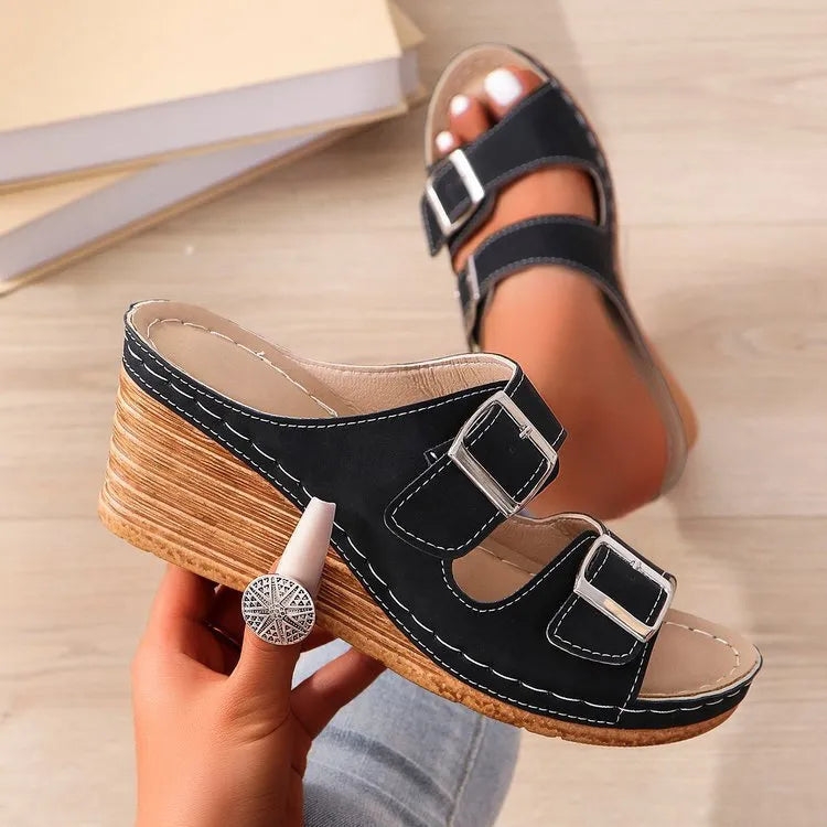 Women's beige wedge heel slippers with a decorative outer buckle fastening on a rubber sole