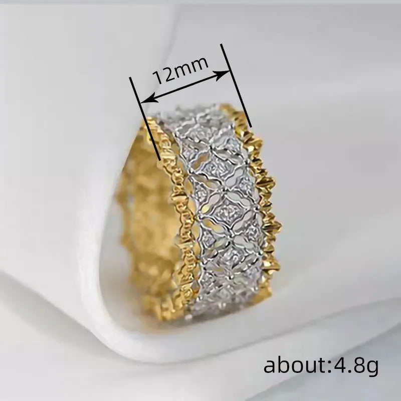 Geometric two-tone gold copper ring with round zircon accents on a solid background.