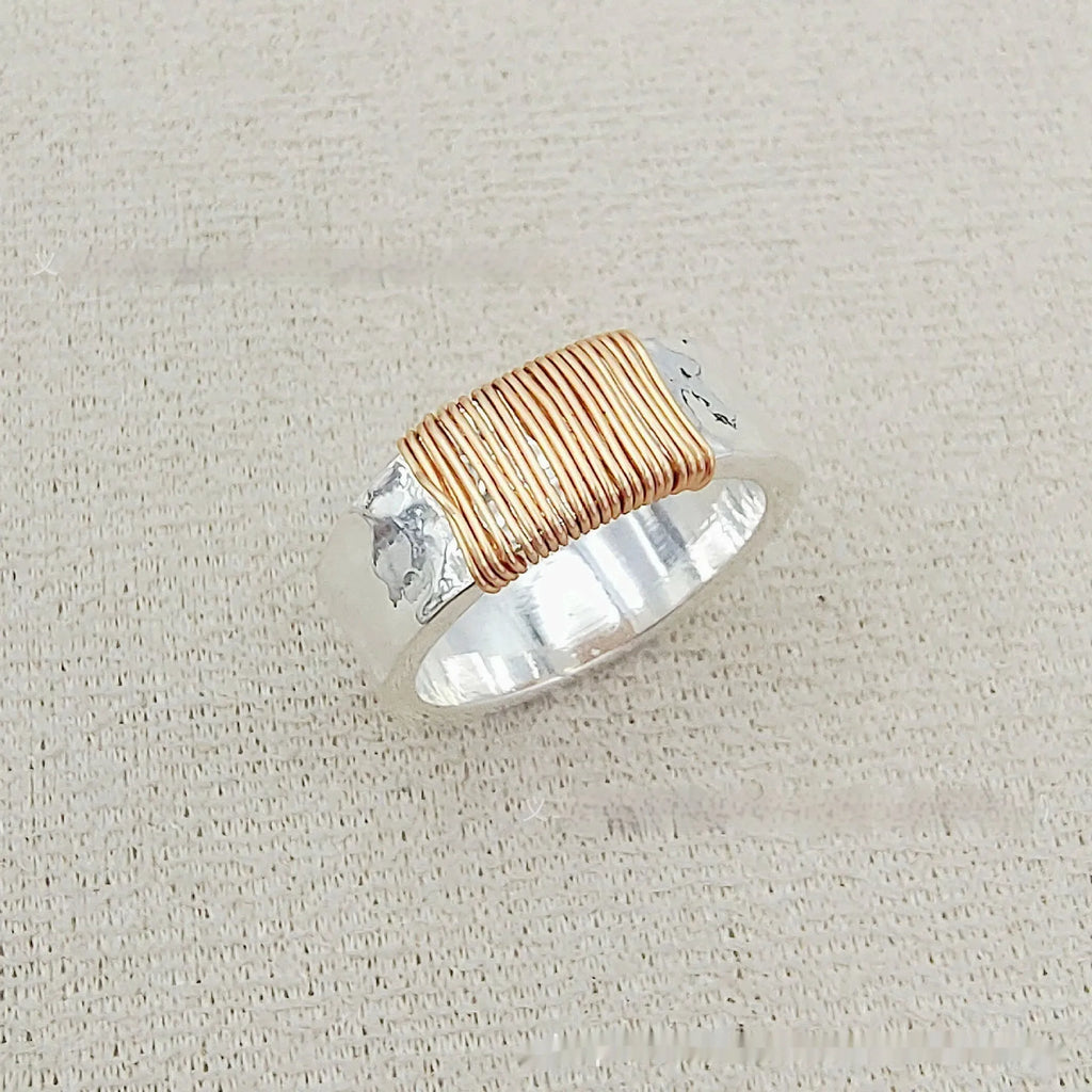 Geometric wide face copper bracelet ring with irregular coil design in silver gold finish.