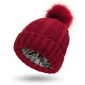 Women's knitted beanie hat with faux fur pom pom and satin lining in a choice of eight colours.