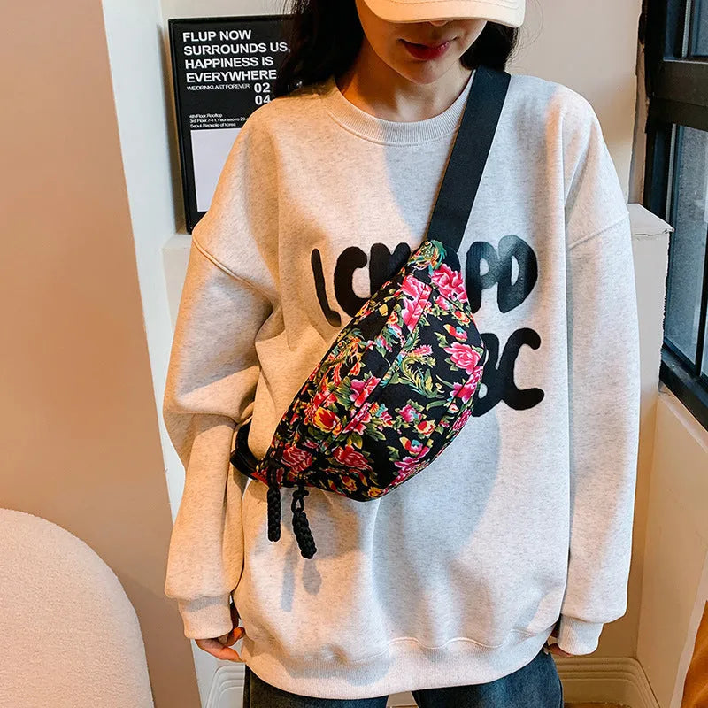 Western style women's waist bag with floral design in black, measuring 32cm wide with 3D pockets