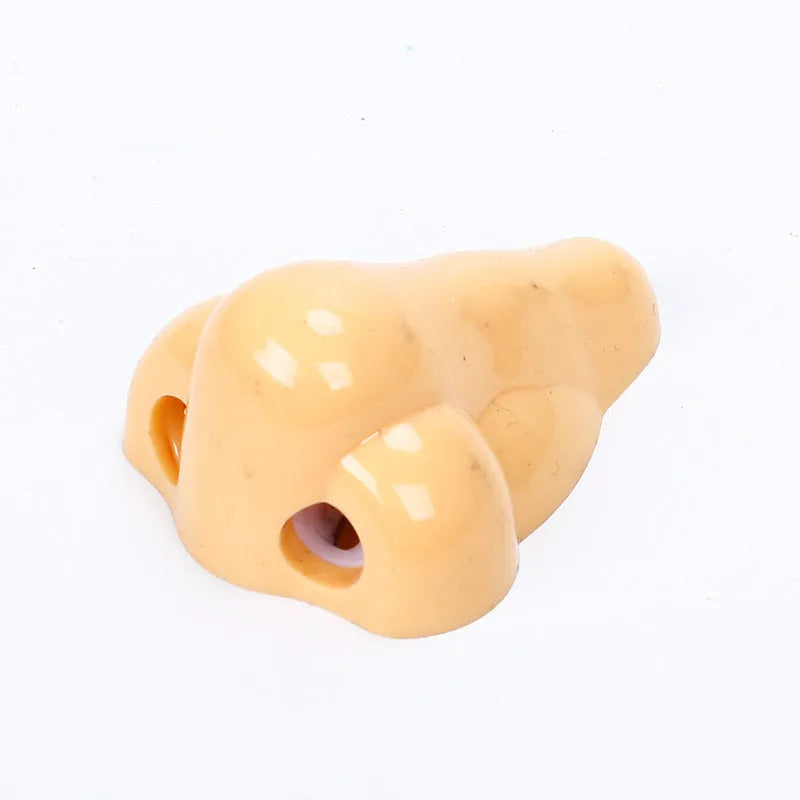 Flesh colour geometric plastic pencil sharpener with big nostril design measuring 58x45x30mm