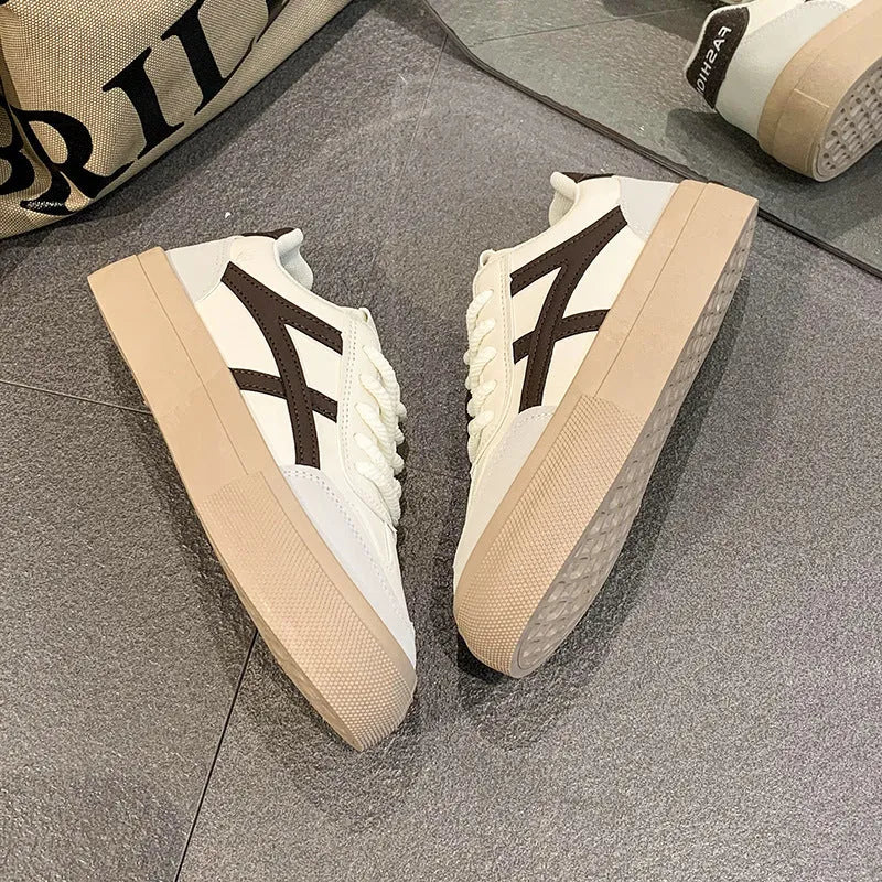 Brown and blue low-top casual lace-up shoes with a patent leather-look finish and flat rubber sole.