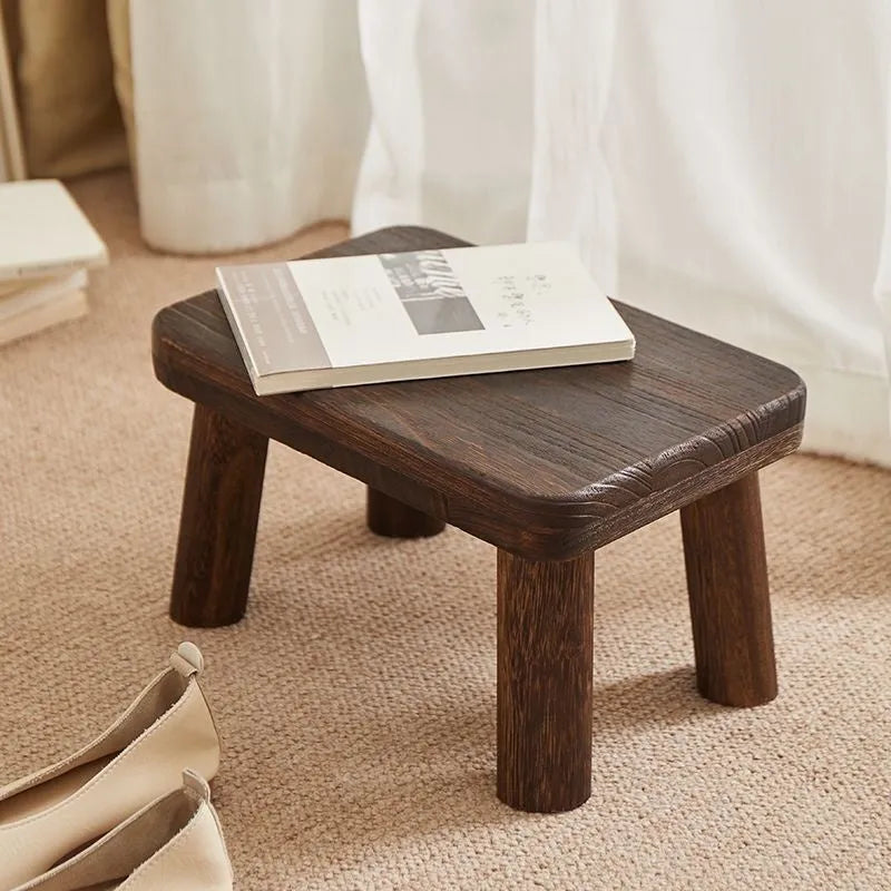 Distressed finish wooden shoes changing stool with bracket construction legs.