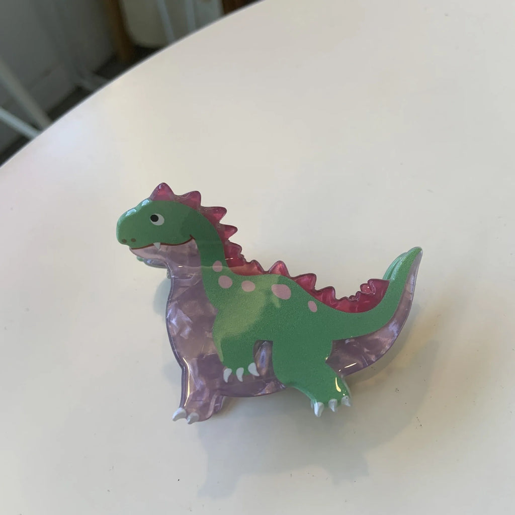 Colourful dinosaur-themed acrylic jaw hair clip showing multiple design options