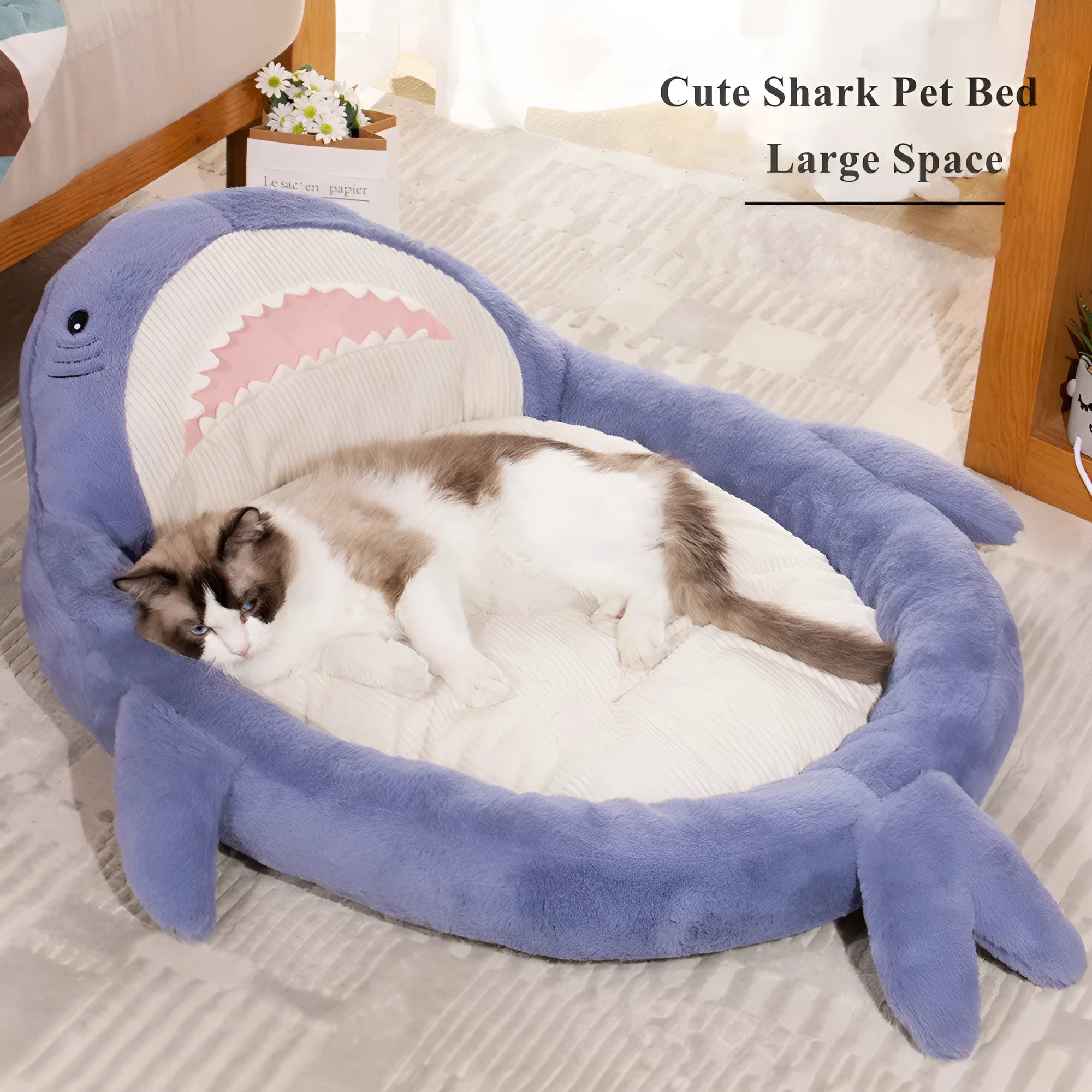 Blue shark pattern pet bed for dogs and cats on a wooden floor, showing plush velvet material.