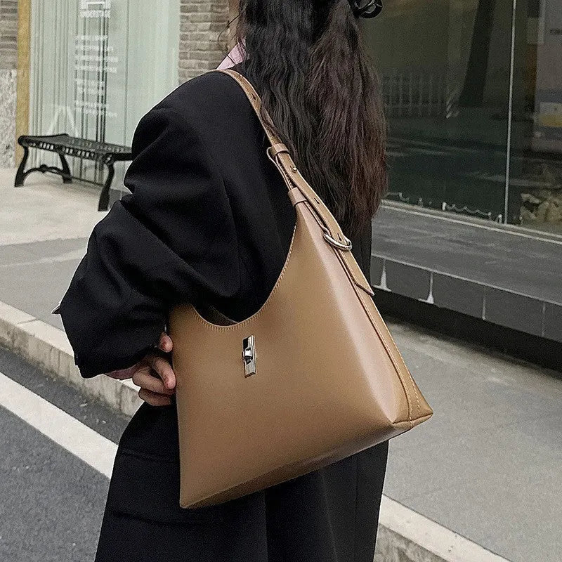 Soft genuine leather crossbody shoulder bag in dumpling shape with internal phone pocket and change compartment