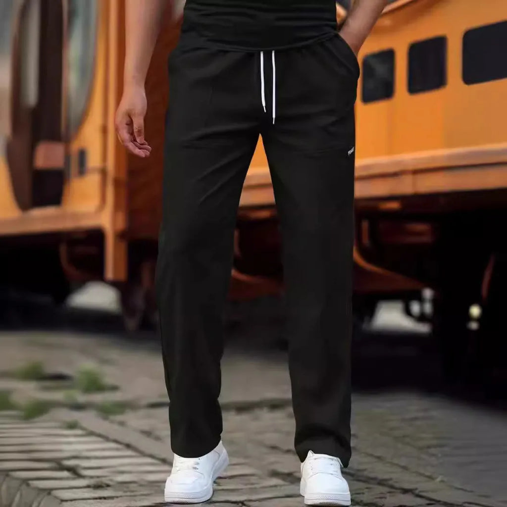 Men's light grey polyester trousers for spring and autumn seasons laid flat.