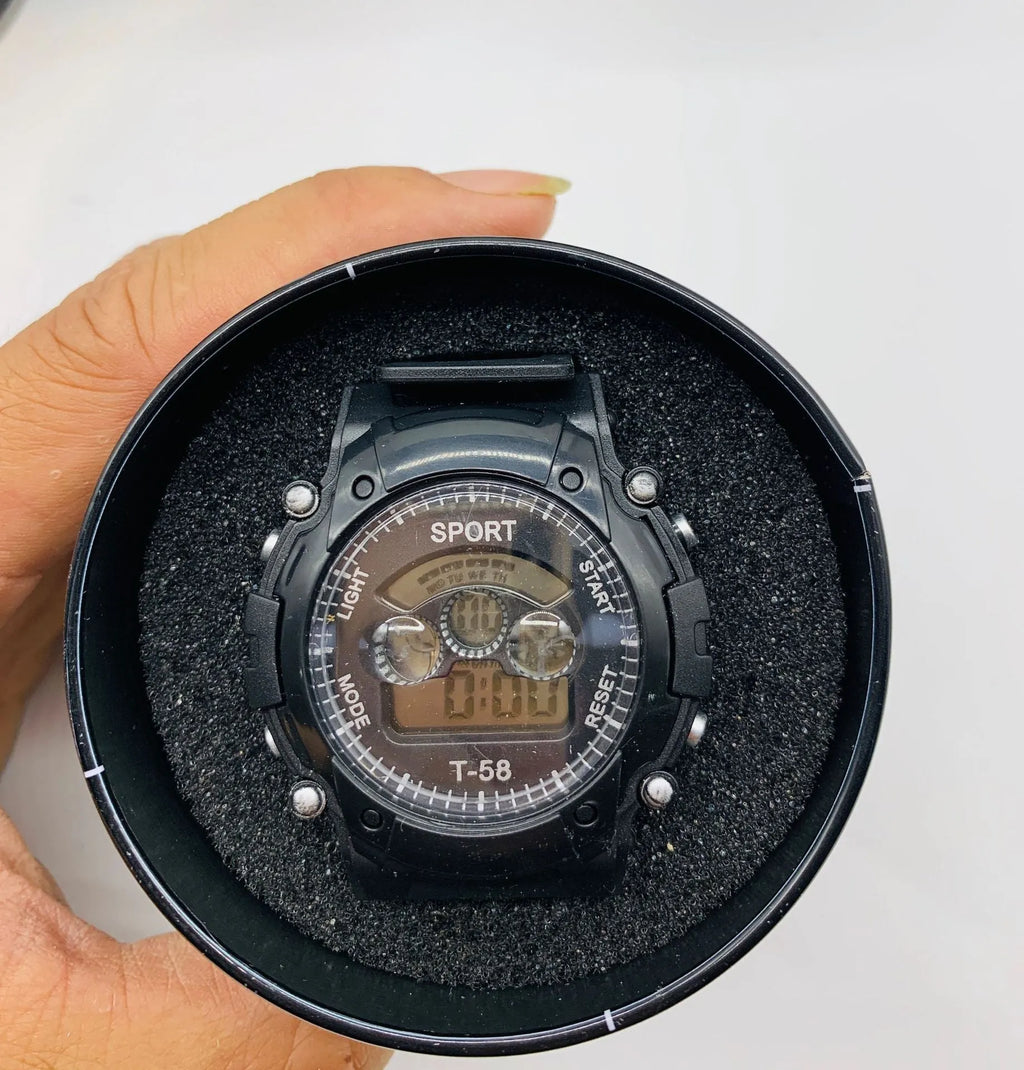 Digital sports watch for children with large face, silicone strap, and display showing time and date.