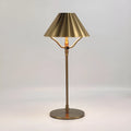 Gold alloy desk lamp with touch switch and interchangeable lampshade on a wooden desk
