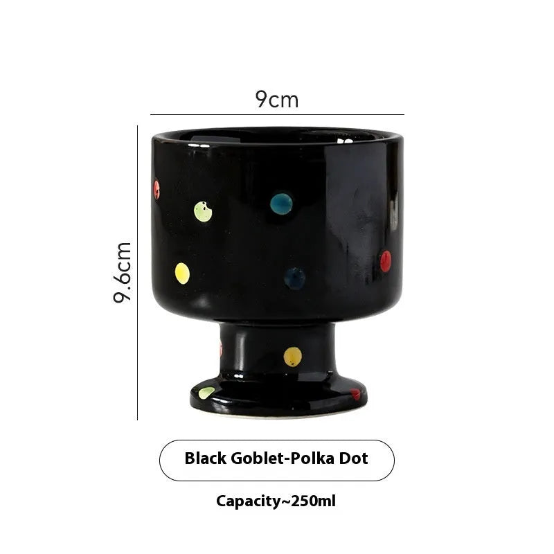 Hand-pinched irregular shaped solid colour ceramic mug on a table, showing its unique form and modern simplicity design.