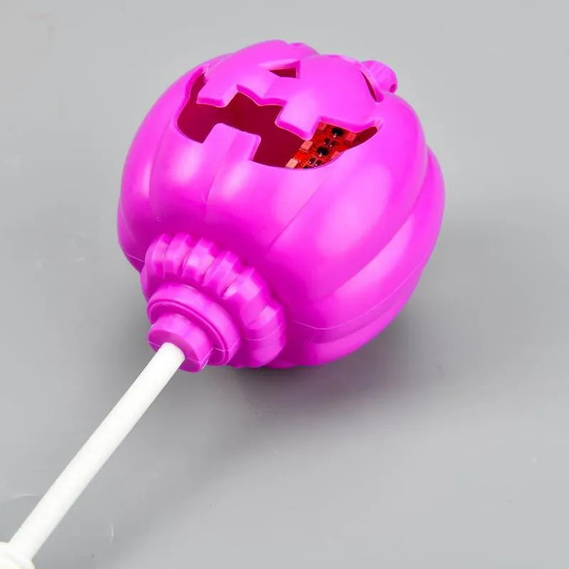 Plastic pumpkin lamp with USB cable showing yellow and purple light options