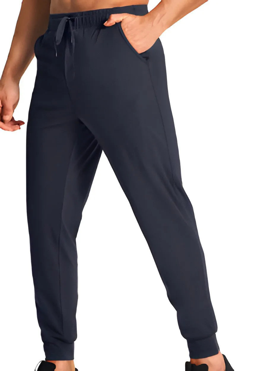 Man wearing loose fit solid colour casual polyester trousers in a leisure setting.