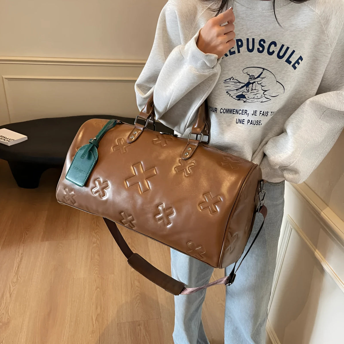 PU embossed travel bag in brown with 20-35L capacity, expansion function, and polyester lining