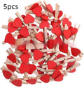 A set of five handmade wooden heart-shaped clips in assorted colours on a plain background.