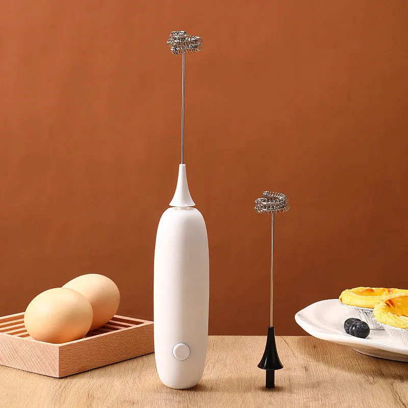 Black and white handheld electric milk frother with modern design for coffee preparation