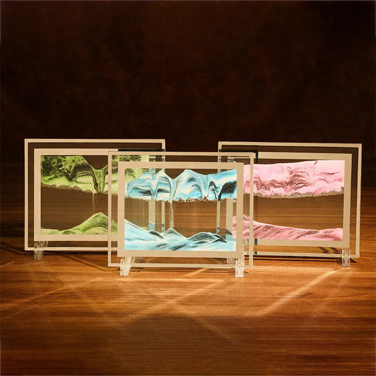 Modern geometric glass quicksand painting ornament with landscape scene on a shelf.