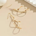 Gold spiral design diamond earrings with geometric shape and elliptical elements