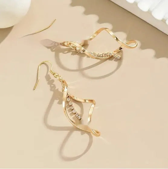 Gold spiral design diamond earrings with geometric shape and elliptical elements