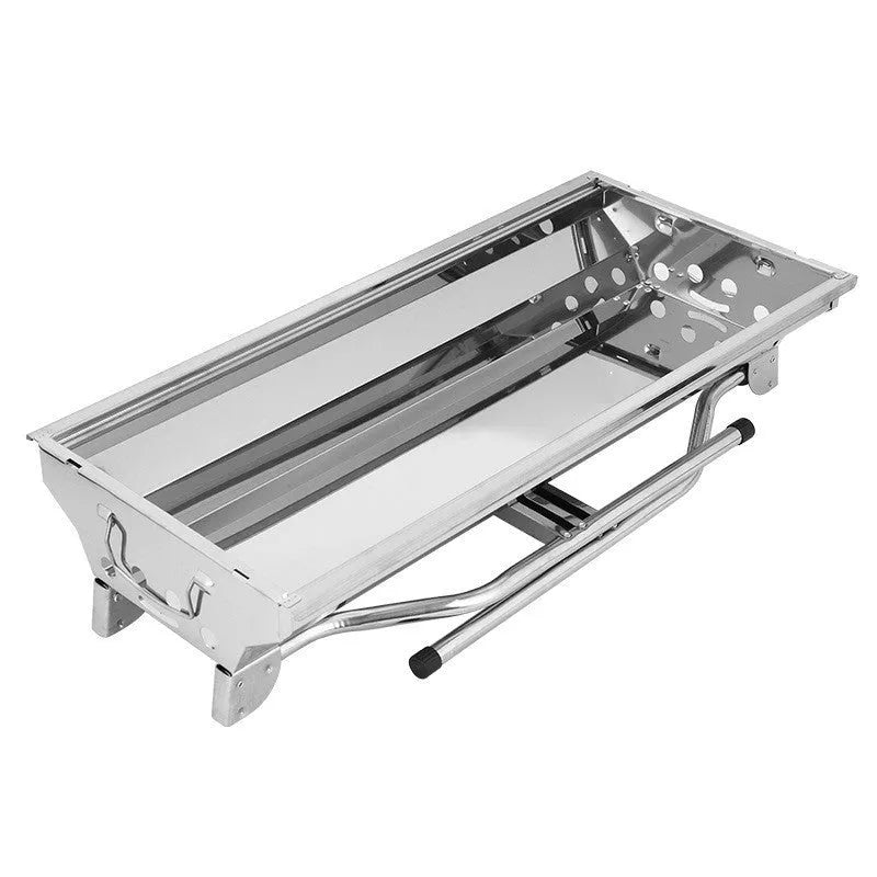 Stainless steel portable folding barbecue grill oven set up outdoors.