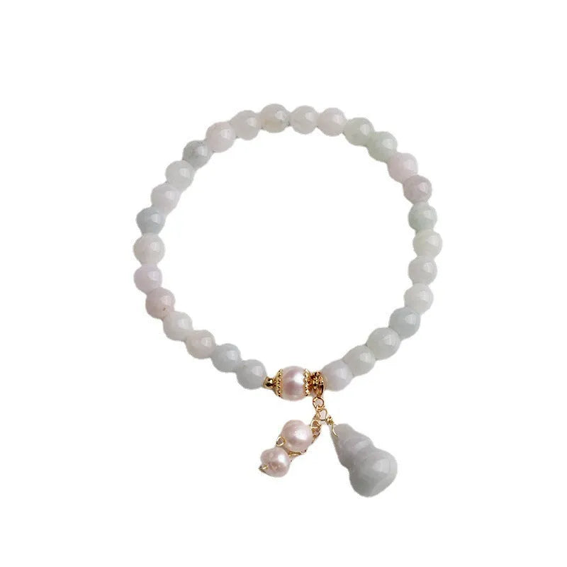 Emerald jade bracelet with hand-carved gourd design in traditional Chinese style