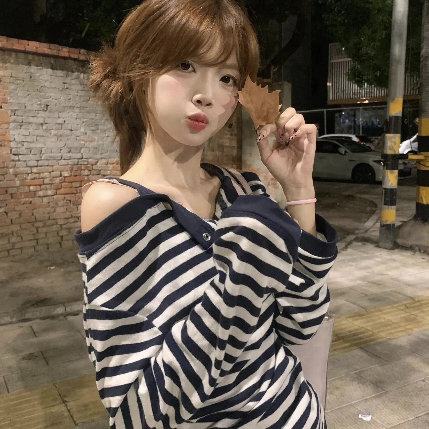 Dark blue Korean-style oversized women's long-sleeved t-shirt with stripes and embroidery detail.
