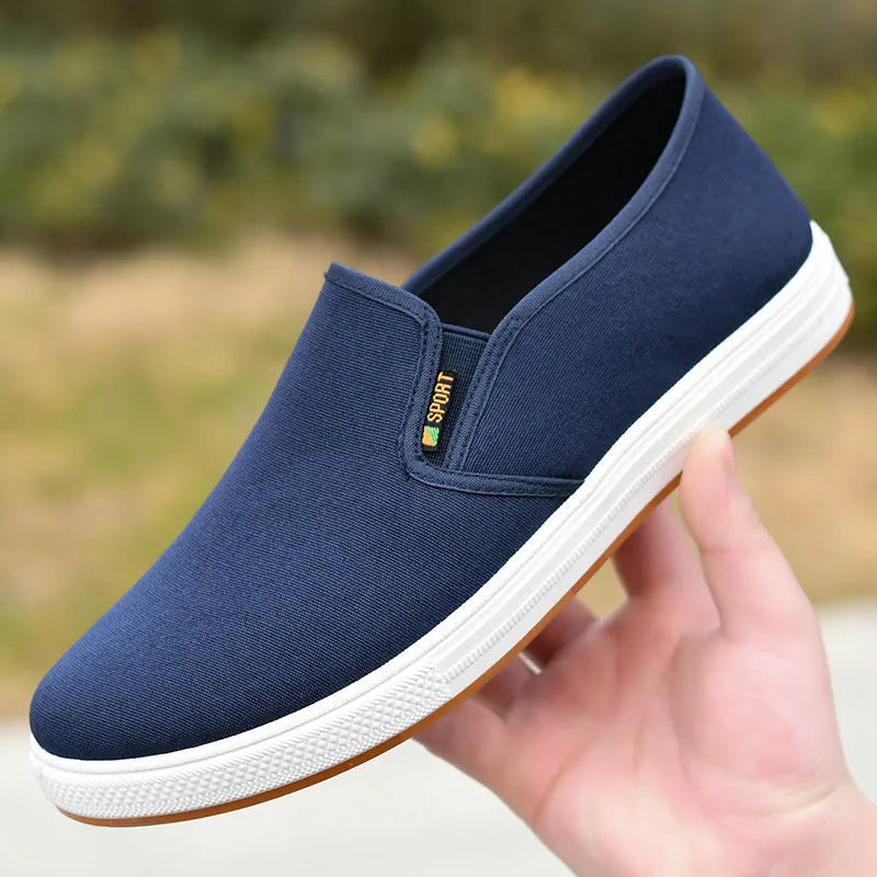 Men's black and blue canvas slip-on shoes with shallow cut design and composite soles