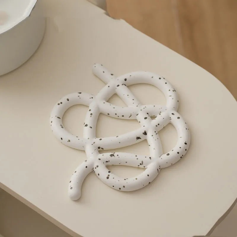 Ceramic heat proof mat with irregular shape on dining table