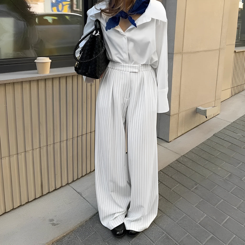 White striped wide-leg women's trousers with a front zip closure on a model