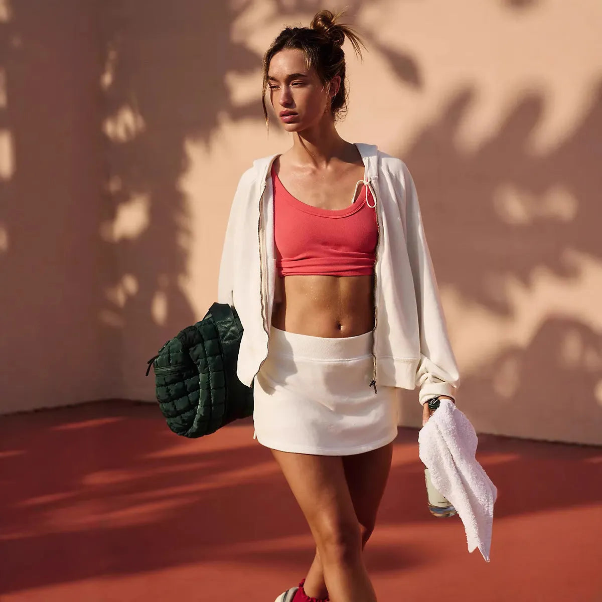 Women's grey street-style hooded jacket and matching mini-skirt co-ord set on a hanger.
