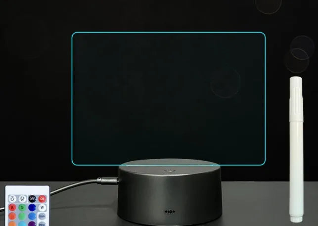 Black 3D acrylic LED night light and message board with stylus on a desktop