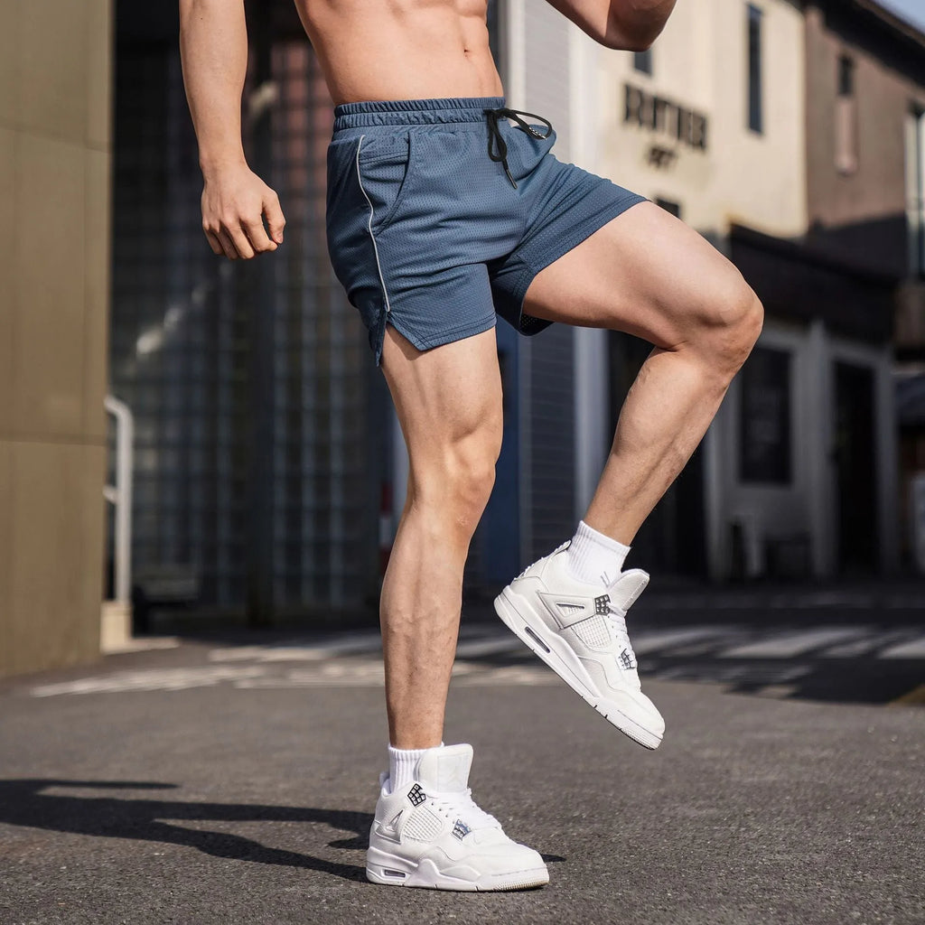Men's straight cut polyester fitness shorts in black, shown in a sports style.