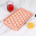 Blue silicone ice cube tray with lid showing 33 round grids for homemade ice