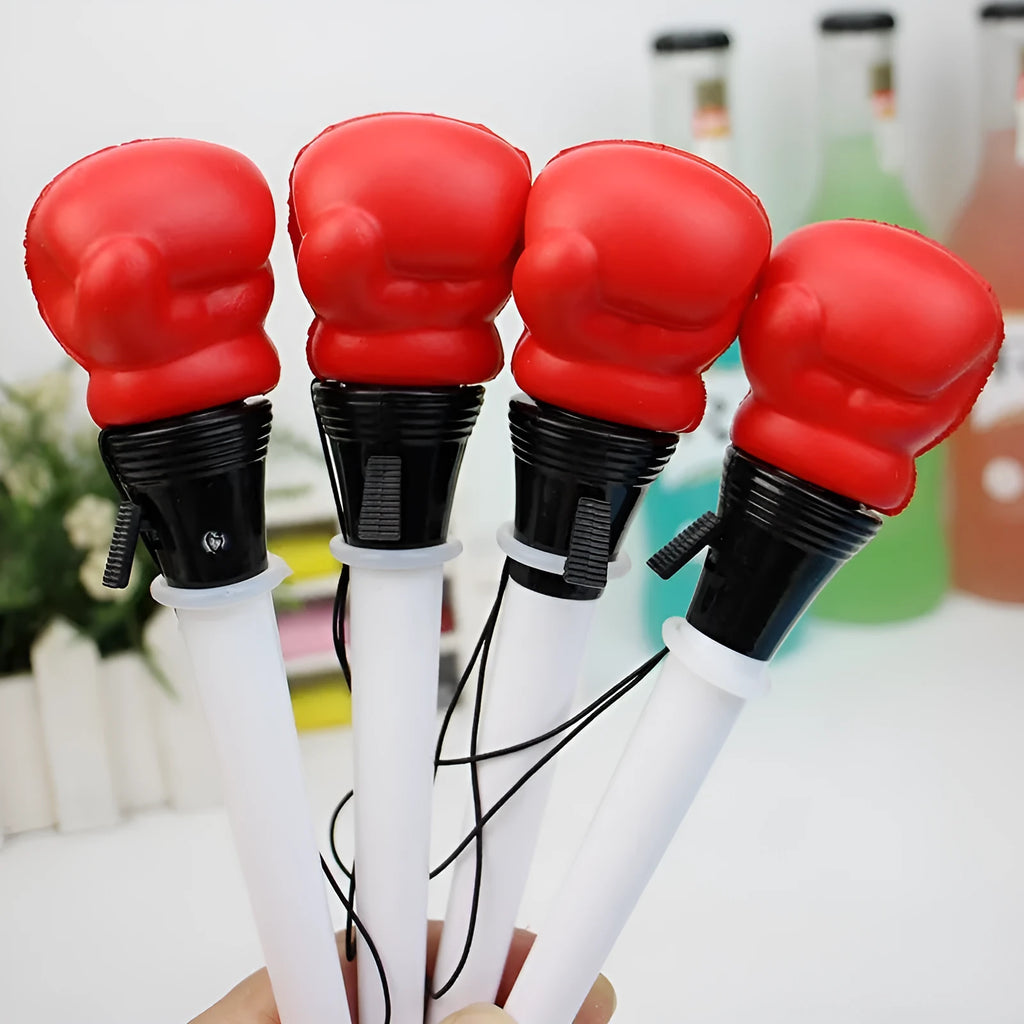 Four pressure relief pens with boxing ejection mechanisms and black ink refills