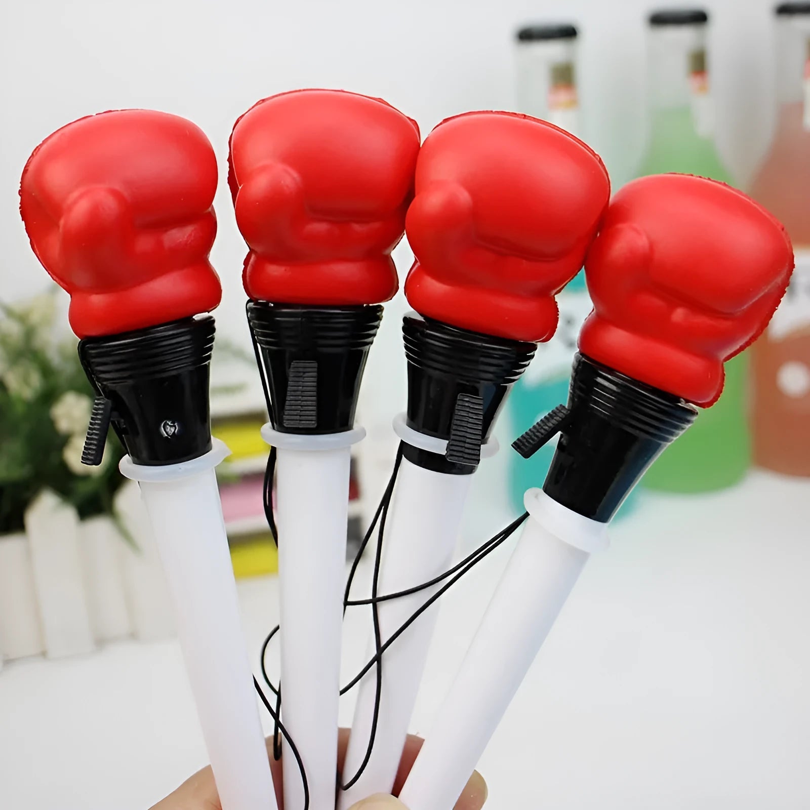 Four pressure relief pens with boxing ejection mechanisms and black ink refills