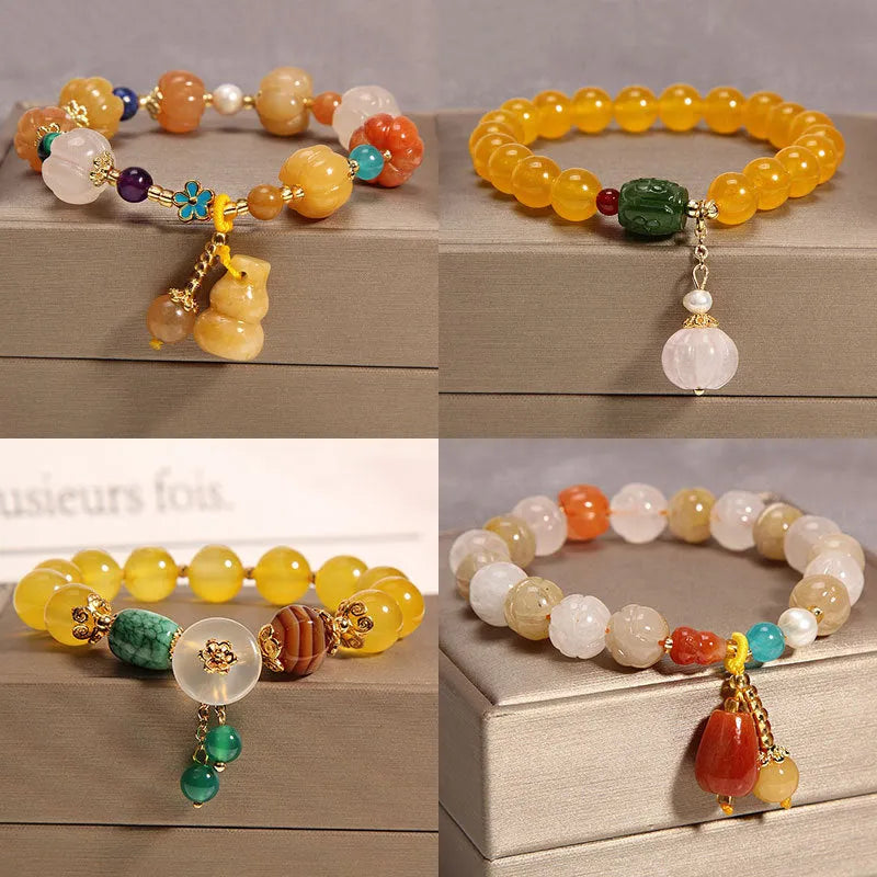 Women's yellow agate crystal bracelet on adjustable gold silk cord.